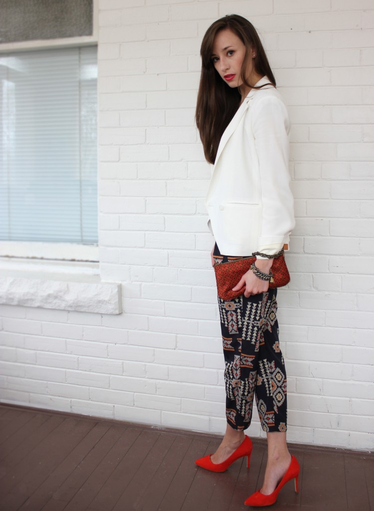 StyleBee wearing tribal pants, red shoes and a white blazer.