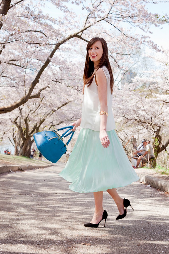 Style Bee in Green Skirt and White Shirt with a Blue Bag