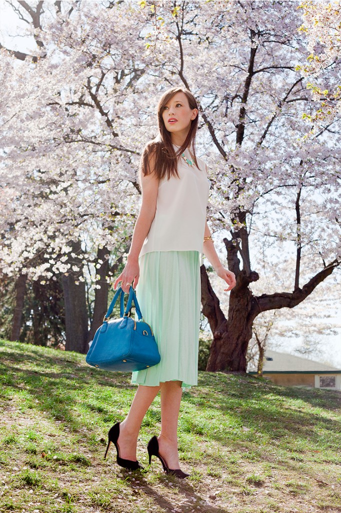 Style Bee in Green Skirt and White Shirt with a Blue Bag