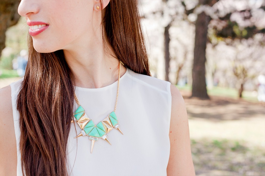 Style Bee in white with green and gold necklace