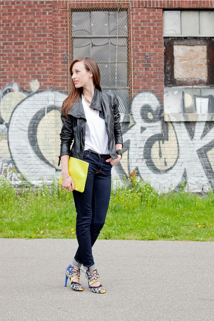 Style Bee in jeans, mixed material heels, a white tee and lime green clutch.