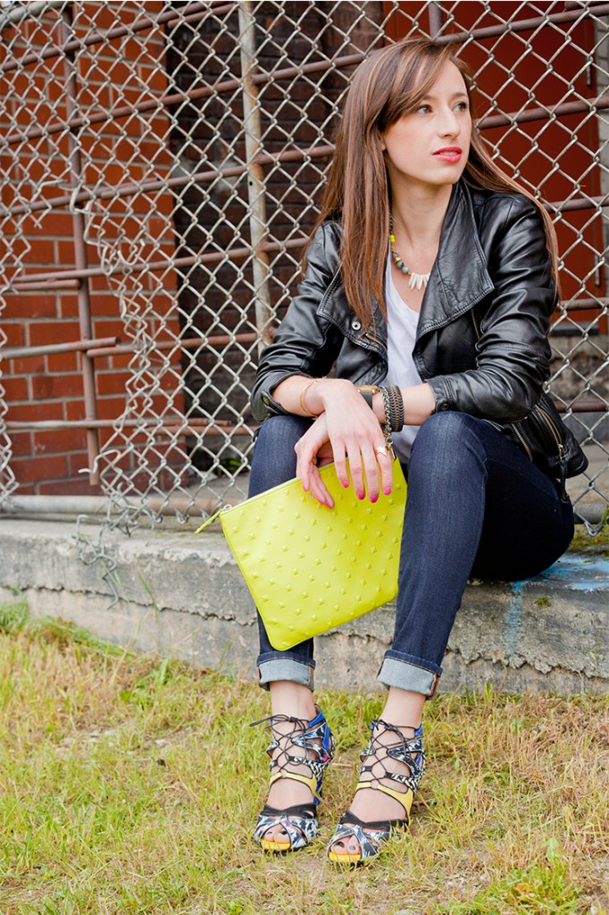 Style Bee in jeans, mixed material heels, a white tee and lime green clutch.