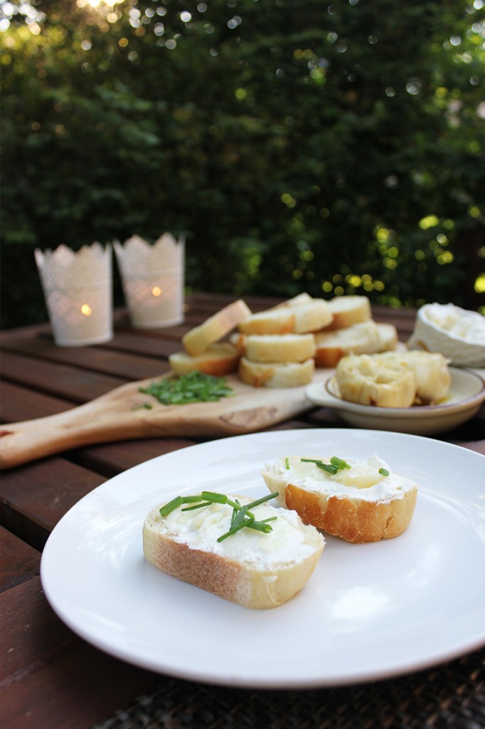 Roasted garlic with bread, cheese and chives.