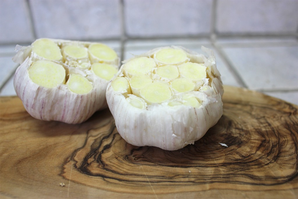 Garlic cloves with tops cut off.