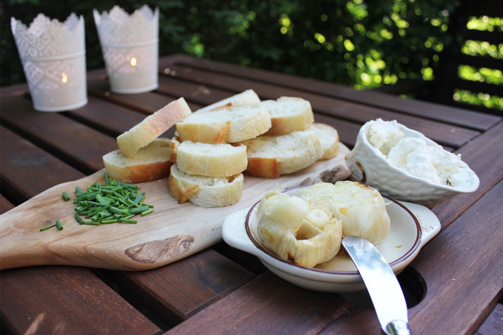 Roasted garlic with bread, cheese and chives.