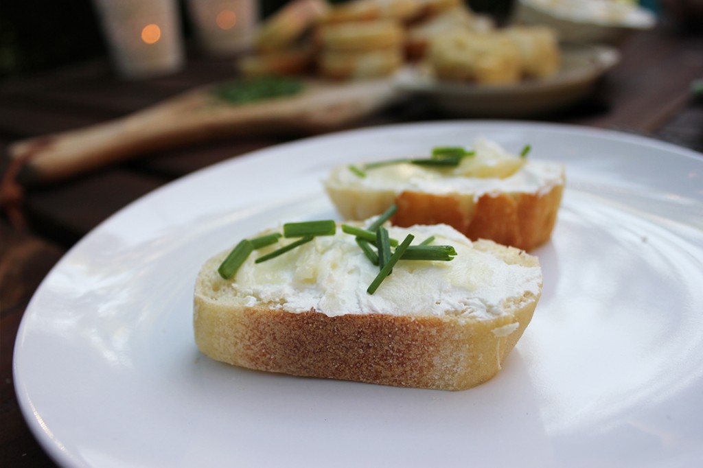 Roasted garlic with bread, cheese and chives.