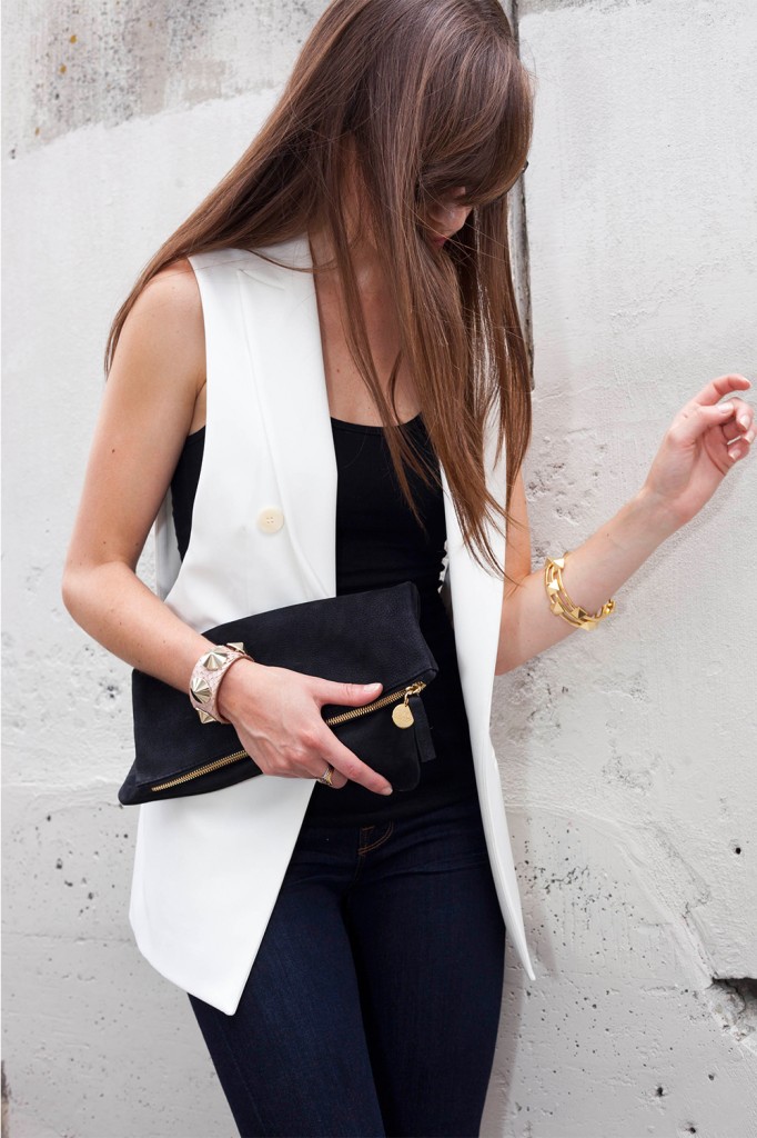 Style Bee in white vest with black top and clutch