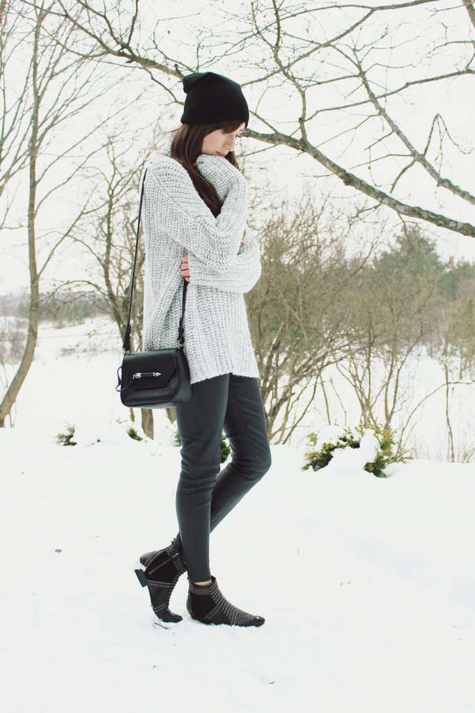 Style Bee in a grey sweater and leather pants.