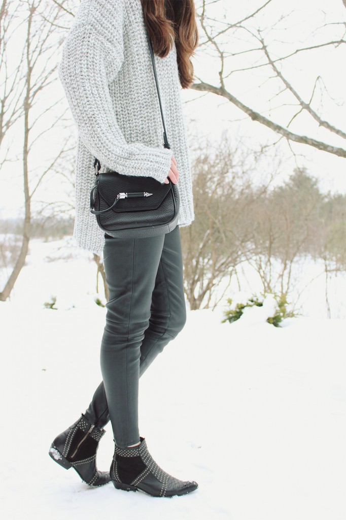 Style Bee in a grey sweater and leather pants.