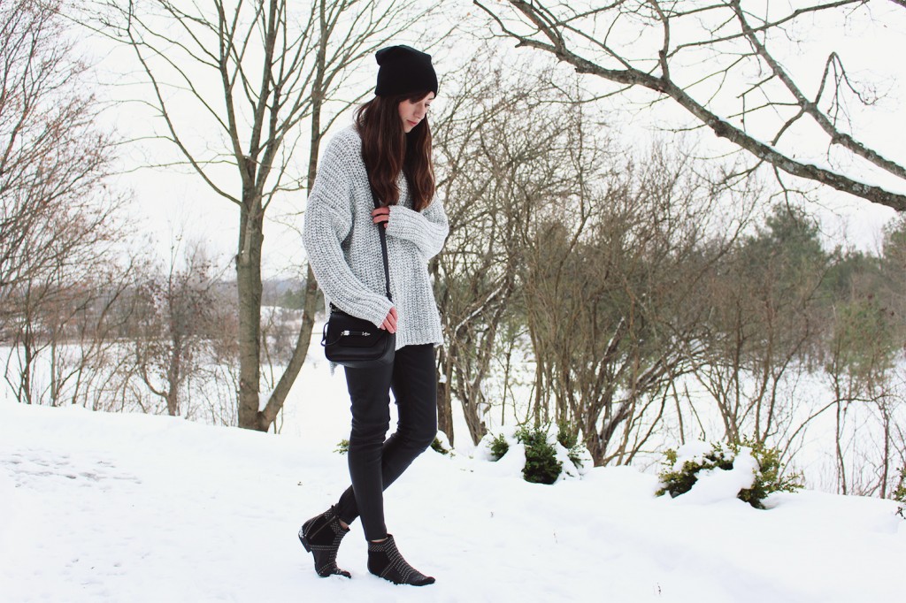 Style Bee in a grey sweater and leather pants.