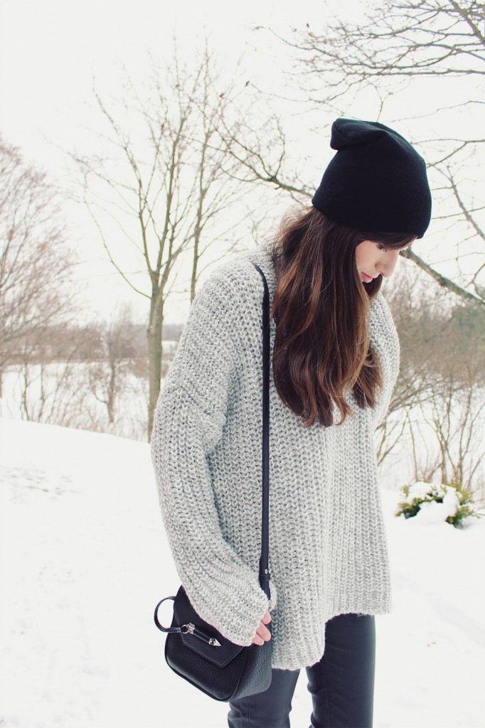 Style Bee in a grey sweater and leather pants.