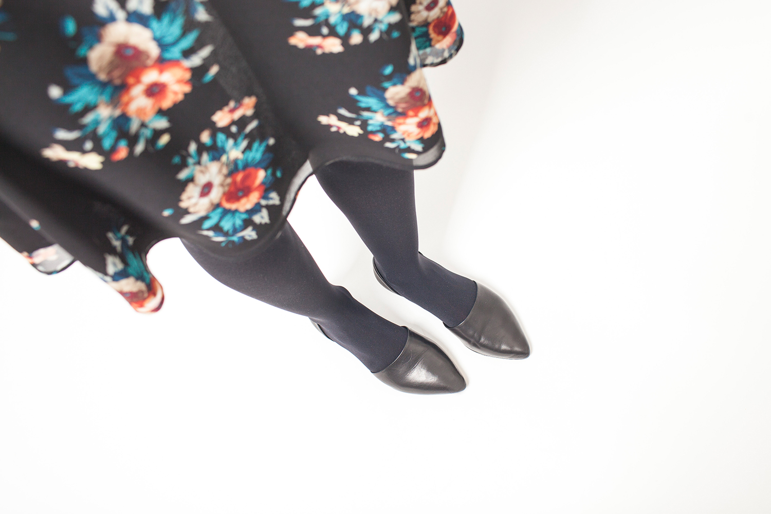 Style Bee in a Floral dress and leather jacket.