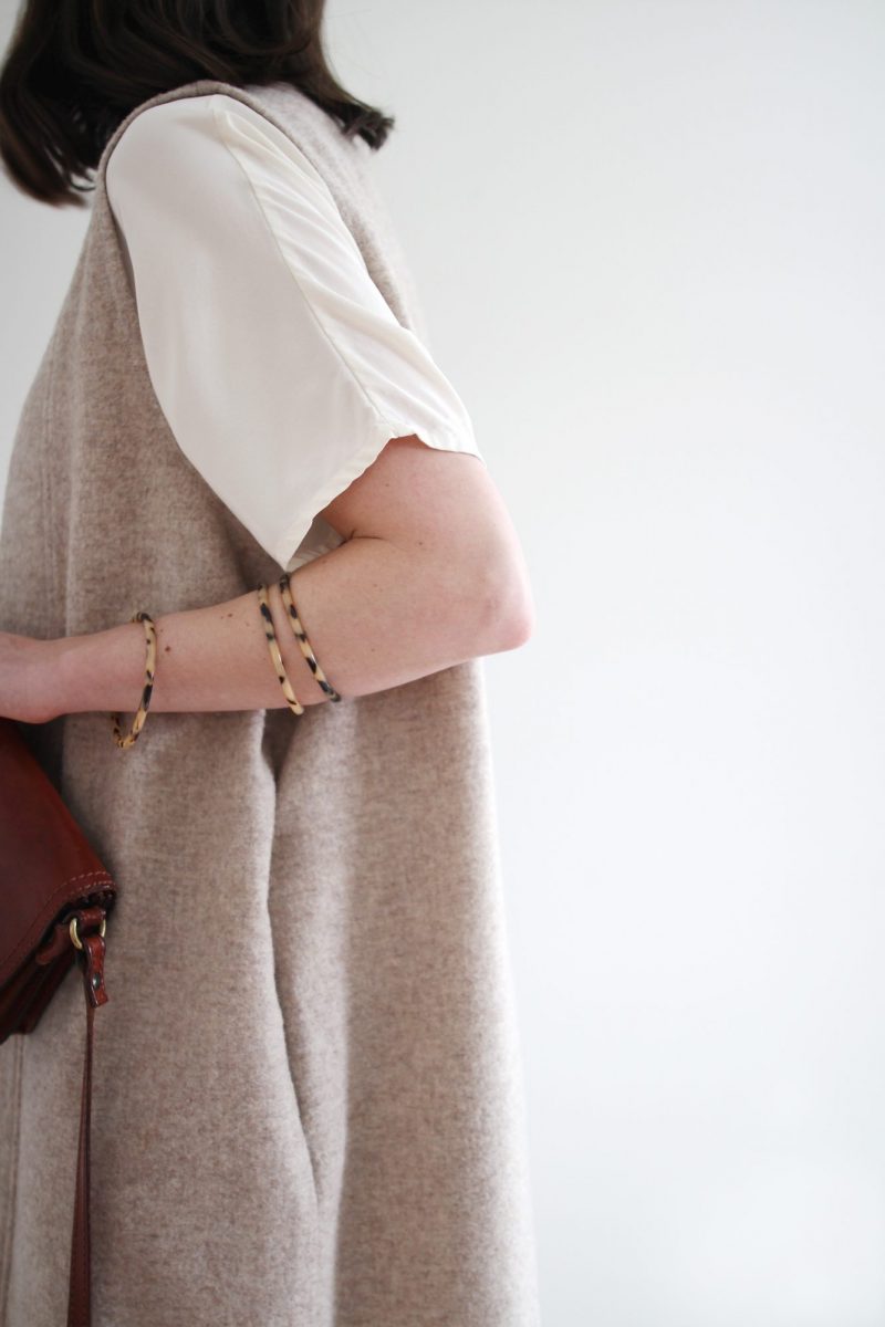 Style Bee - Winter Palette - Black Slim Pant + Loose White Top + Wool Vest + Taupe Boots + Tortoise Bangles